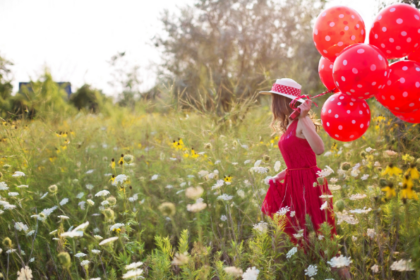 happy woman with red balloons